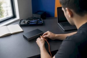 Hands connecting network cable in training lab